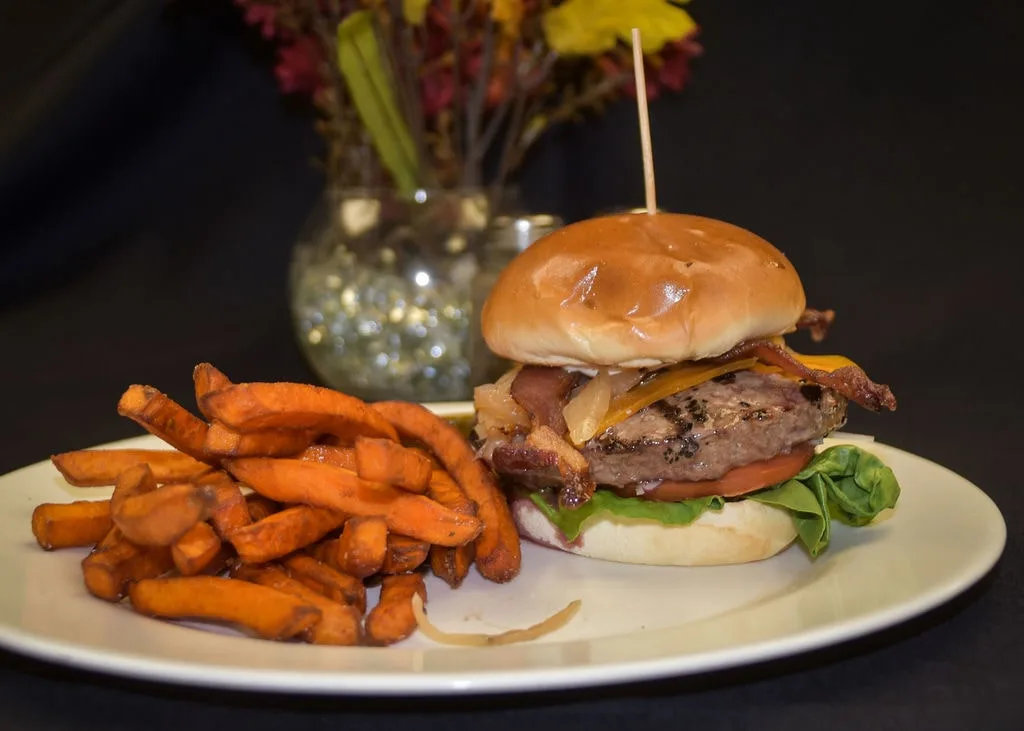 Classic bacon cheeseburger with a side of sweet potato fries, a local favorite in Branford.