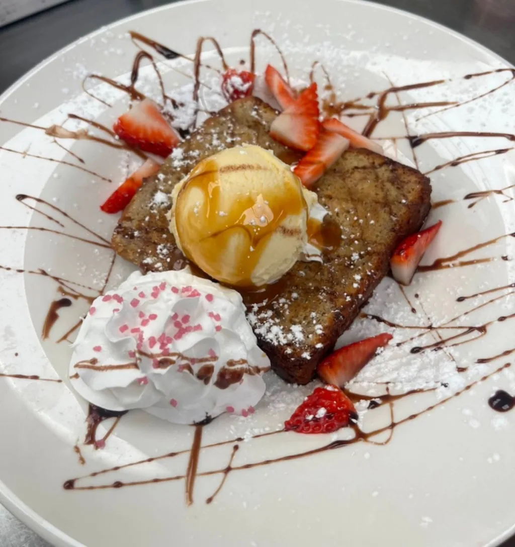 Sweet french toast topped with ice cream, a unique dessert treat.