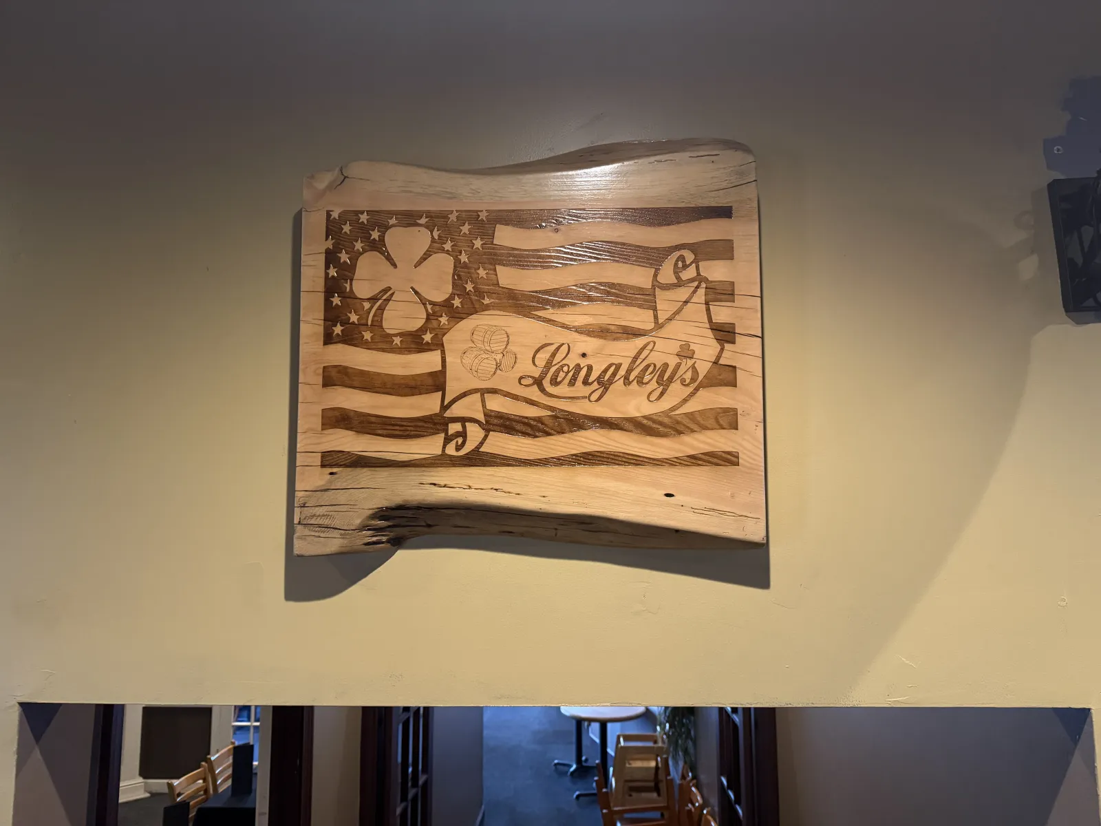 Longley's carved wooden sign with the American flag out front.