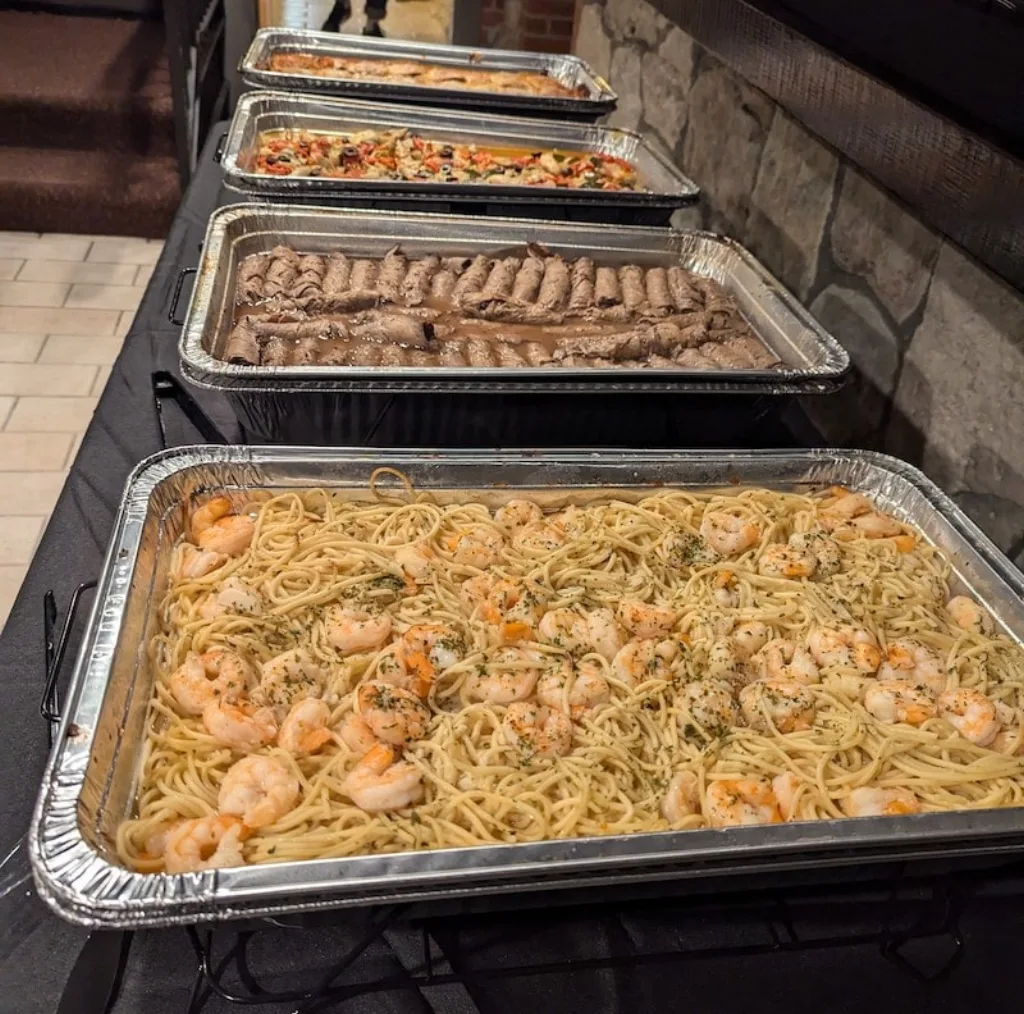 Longley's catering buffet featuring shrimp scampi and roast beef for events.