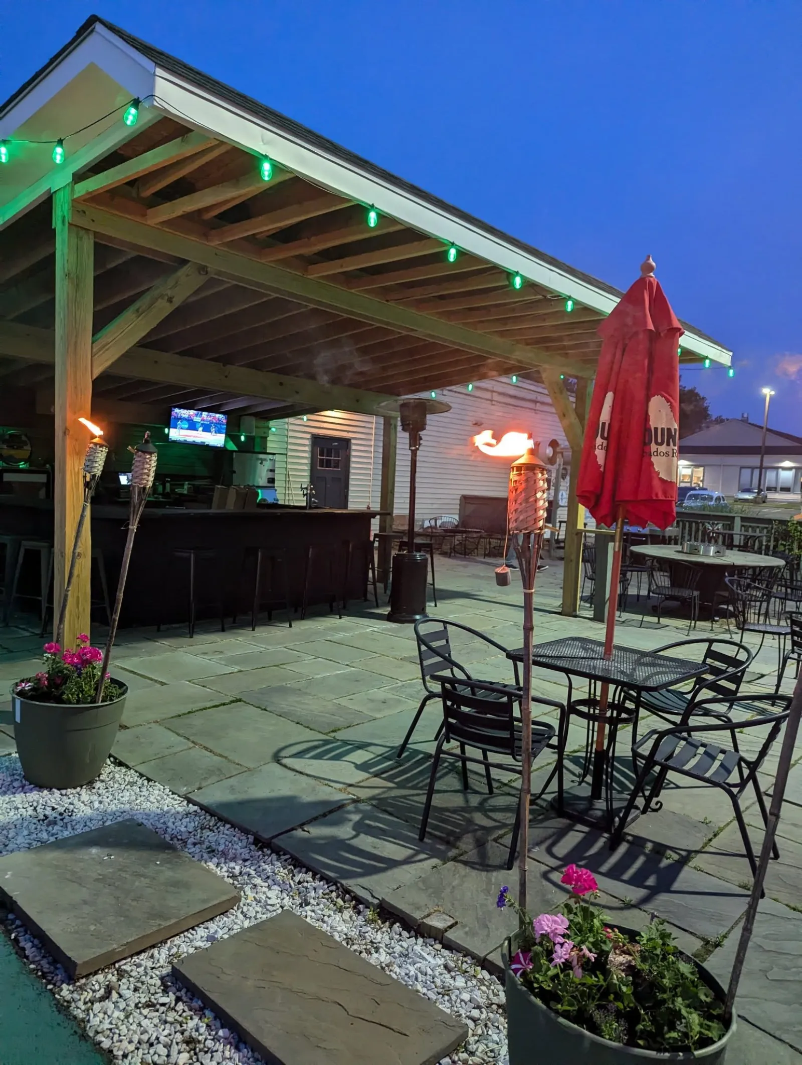 Covered patio bar lit up at night at Longley's in Branford CT.