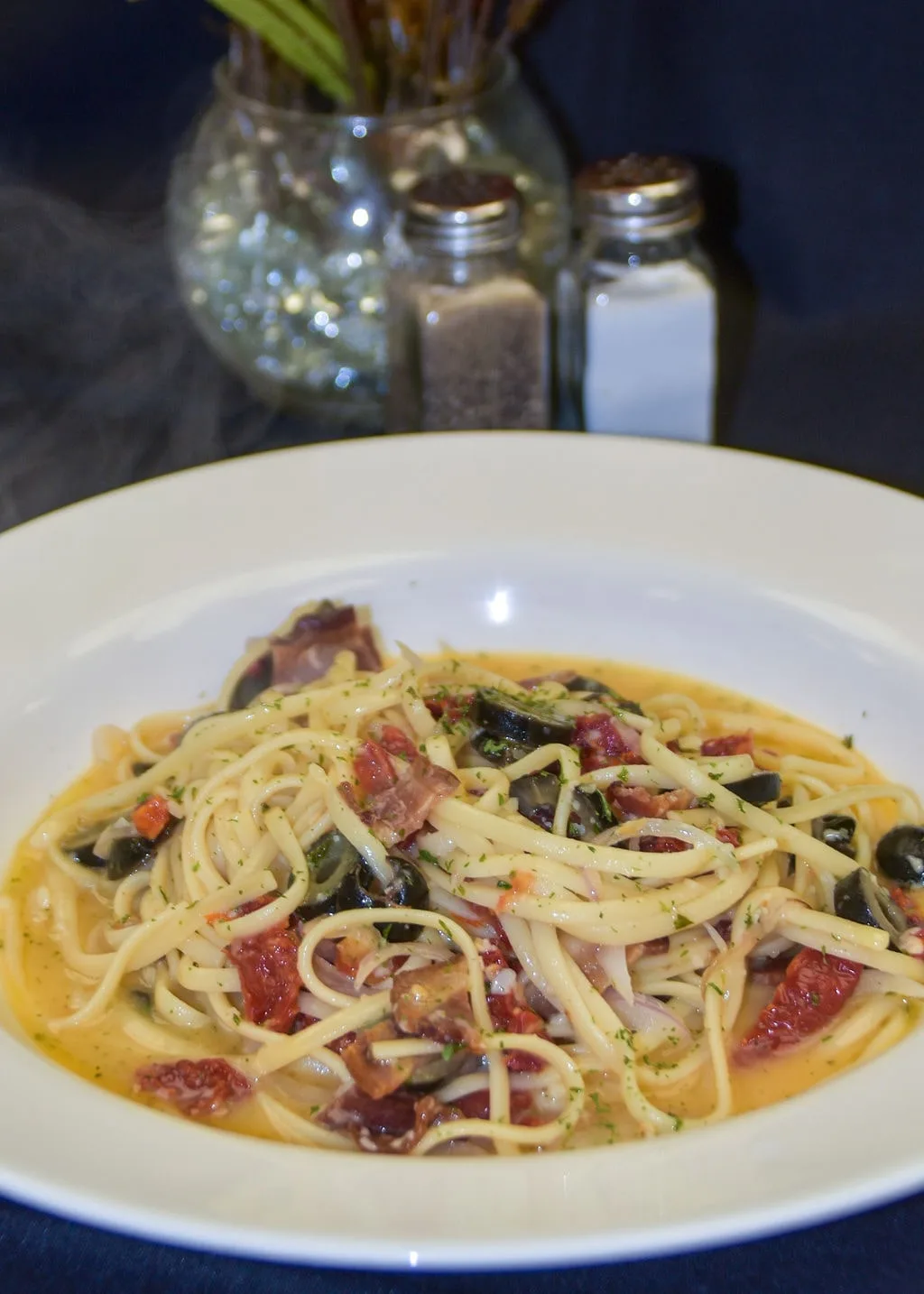 Pasta with olives, bacon, and sun-dried tomatoes, full of flavor.