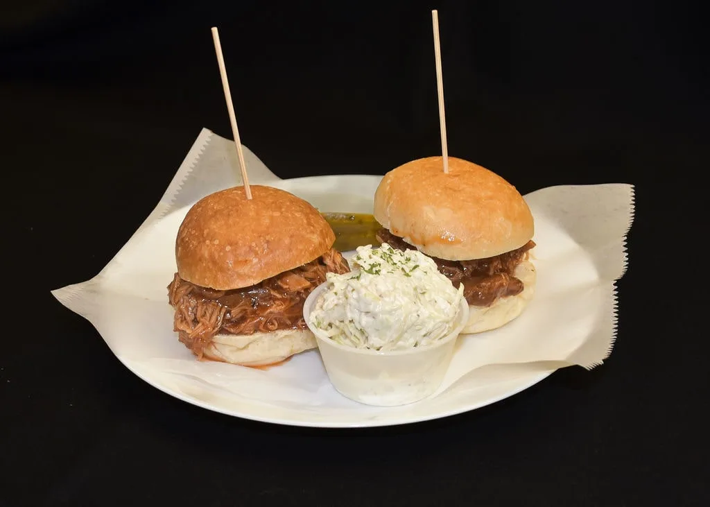 Pulled pork sliders topped with coleslaw, a perfect appetizer or late night snack.