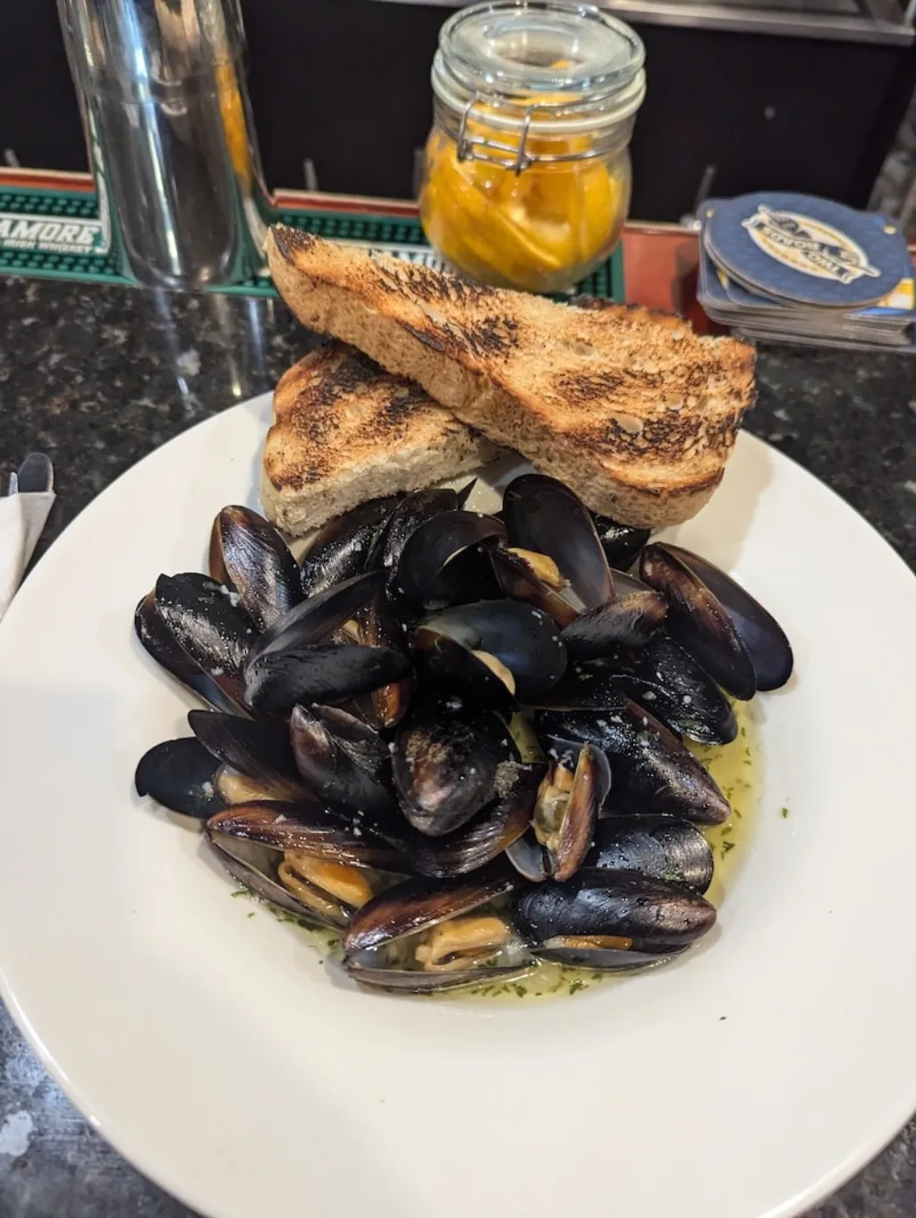 Steamed mussels in white wine garlic sauce served with toast in Branford.
